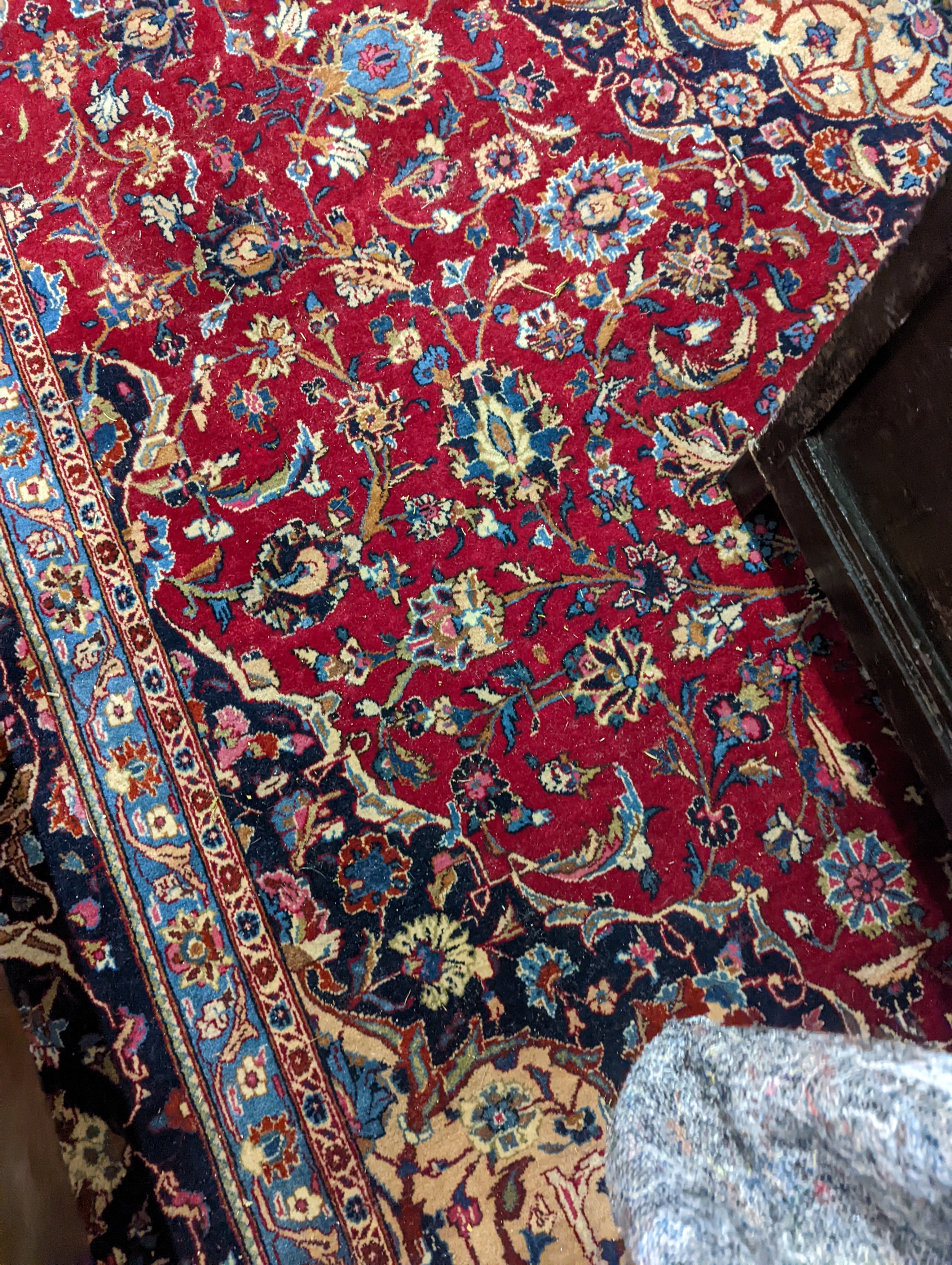 A Kashan burgundy ground carpet, 380 x 300cm